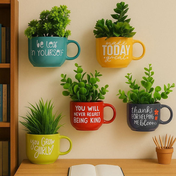 Decorative wall-mounted mugs with plants inside, each containing a motivational quote.