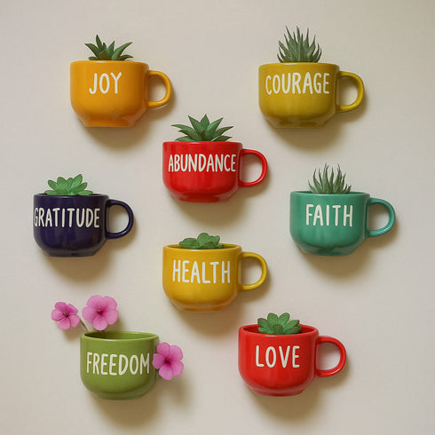 Colorful mugs with motivational words and plants on a beige background