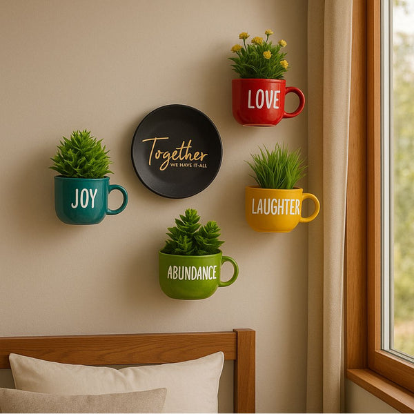 Decorative wall art with mugs and plants on a wall near a window.
